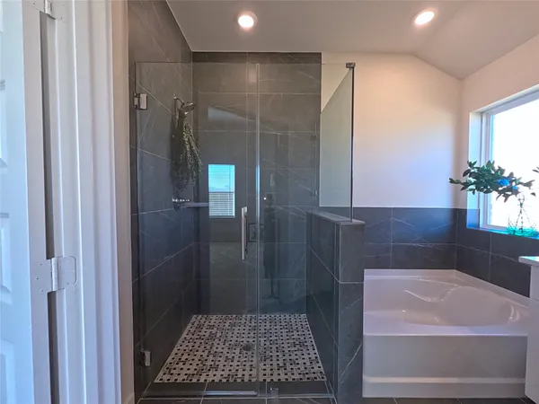 a bathroom with a double vanity sink a mirror and a bathtub