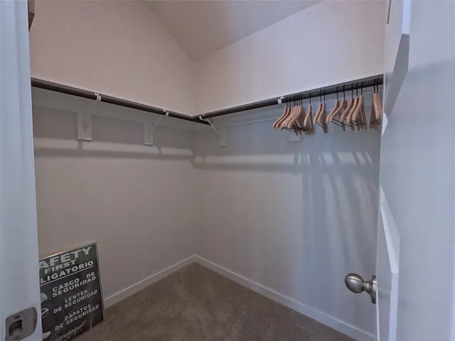 a view of a kitchen with kitchen island a counter top space a sink appliances and cabinets