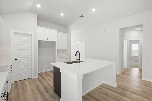 a view of a kitchen cabinets a sink and wooden floor