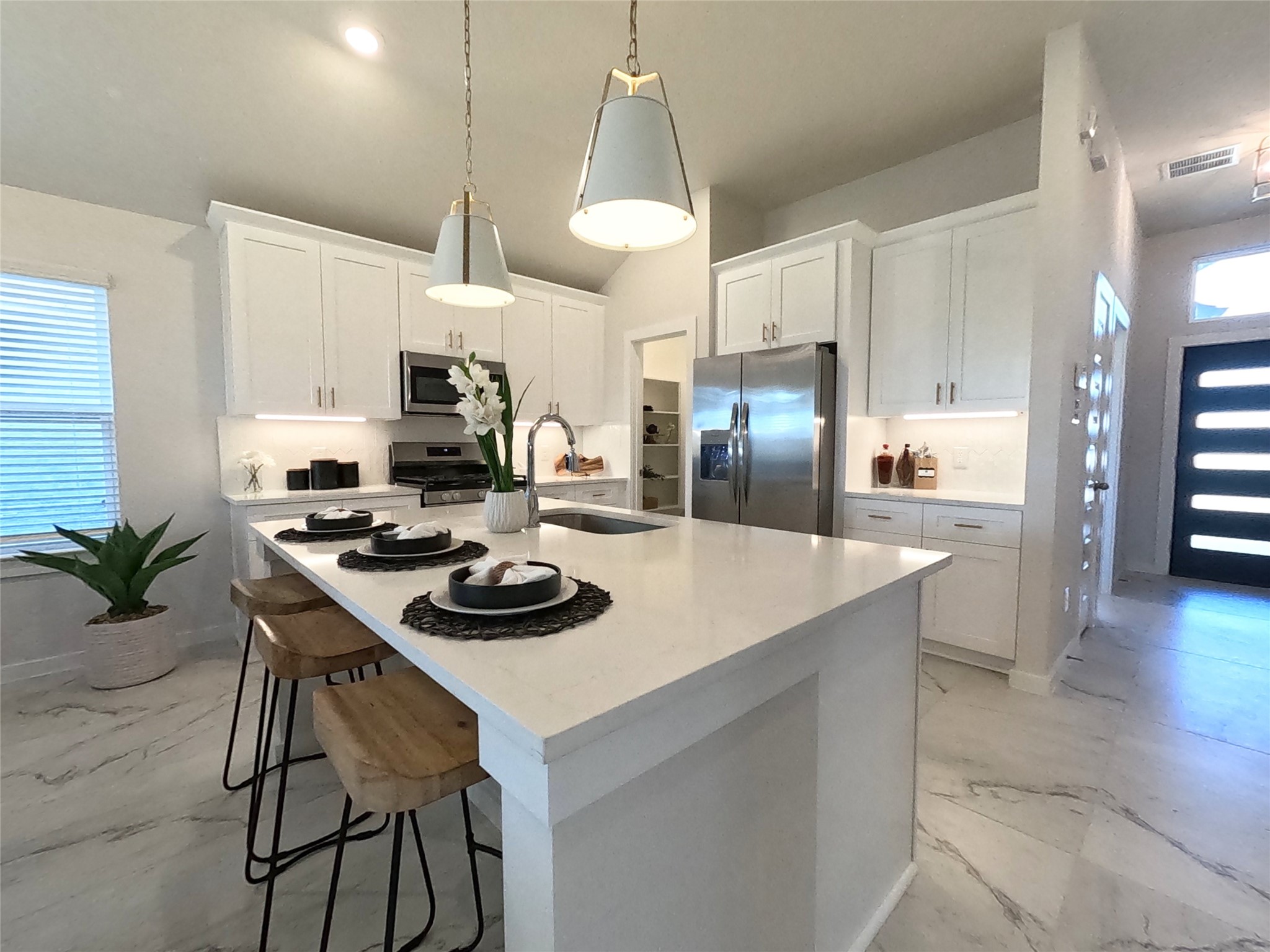8323 Amber Summit Lane Angleton, TX 77515 - Photo 9 of 24 a kitchen with a stove a refrigerator and a dining table