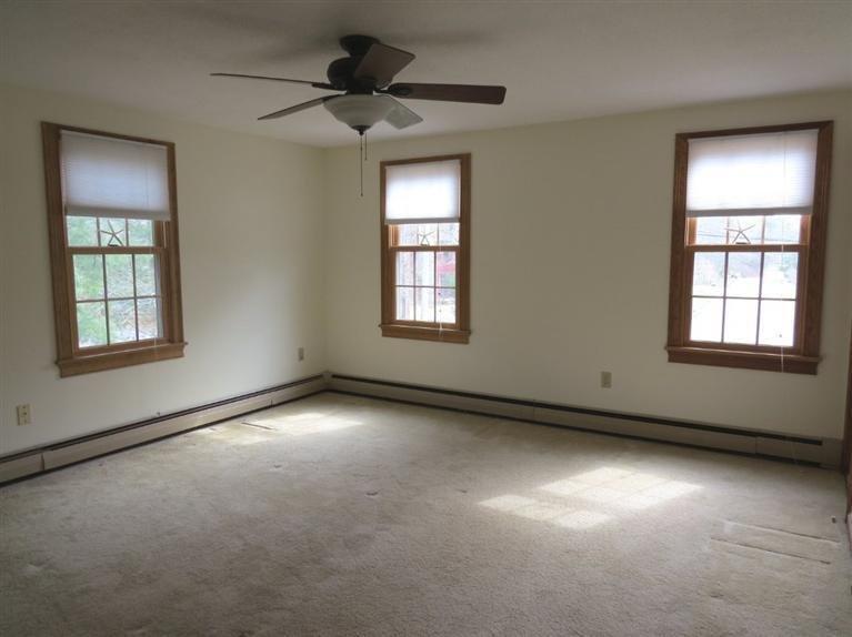 181 Cap'n Lijah's Road Centerville, MA 02632 - Photo 13 of 25 an empty room with a window and a ceiling fan