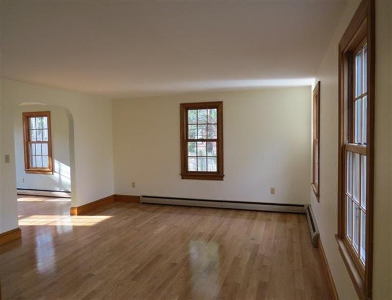 181 Cap'n Lijah's Road Centerville, MA 02632 - Photo 3 of 25 an empty room with wooden floor and windows
