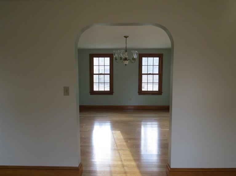 181 Cap'n Lijah's Road Centerville, MA 02632 - Photo 4 of 25 an empty room with wooden floor and windows