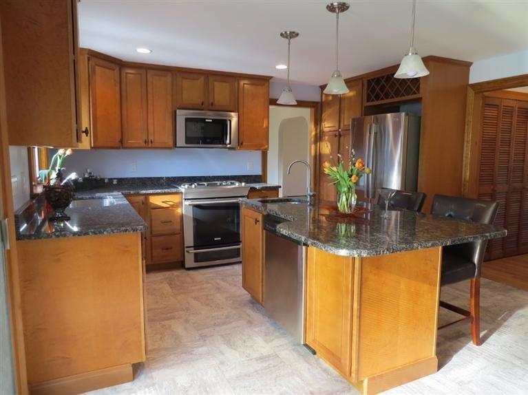 181 Cap'n Lijah's Road Centerville, MA 02632 - Photo 6 of 25 a kitchen with stainless steel appliances granite countertop a stove refrigerator and microwave