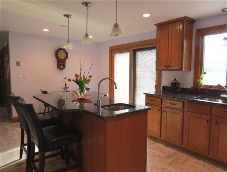 181 Cap'n Lijah's Road Centerville, MA 02632 - Photo 8 of 25 a kitchen with granite countertop a sink cabinets and window