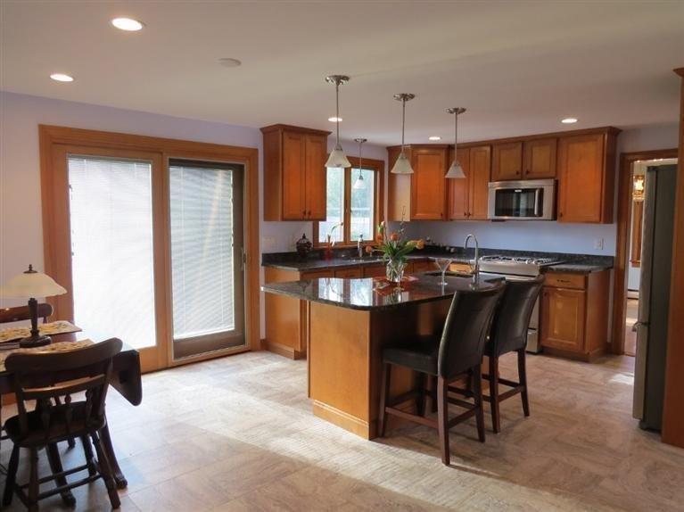 181 Cap'n Lijah's Road Centerville, MA 02632 - Photo 9 of 25 a kitchen with stainless steel appliances granite countertop table chairs sink and cabinets