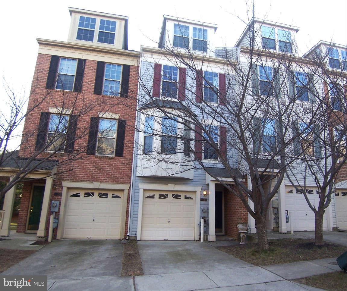 29 Bank Spring Court Owings Mills, MD 21117 - Photo 1 of 16 a front view of a building with a yard