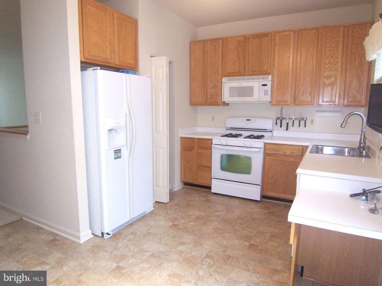 29 Bank Spring Court Owings Mills, MD 21117 - Photo 5 of 16 a kitchen with a stove top oven sink and cabinets