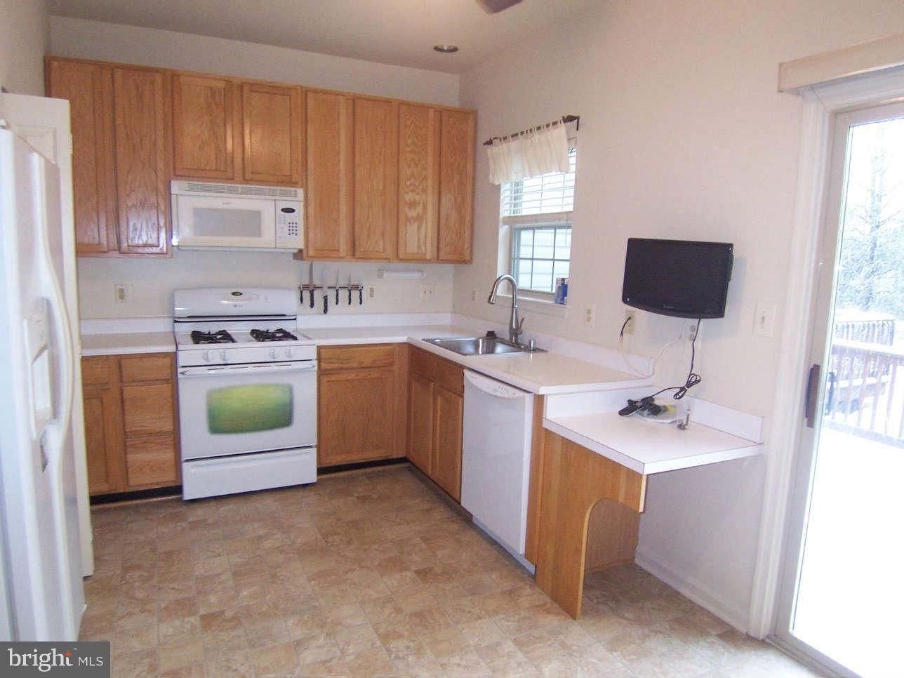 29 Bank Spring Court Owings Mills, MD 21117 - Photo 6 of 16 a kitchen with a sink cabinets and window
