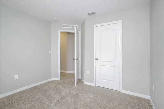 an empty room with closet area