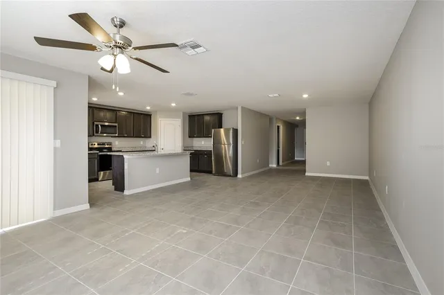 a view of a kitchen with a sink and stainless steel appliances