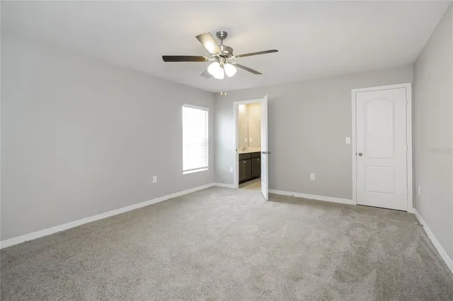 a view of an empty room with a ceiling fan