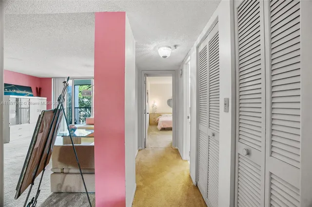 a hallway with a view of living room