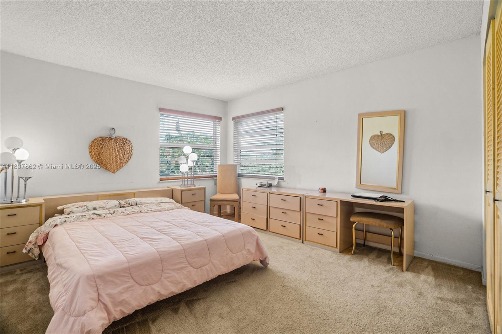 3940 Inverrary Boulevard, Unit 304A Lauderhill, FL 33319 - Photo 16 of 28 a bedroom with a bed and a chandelier