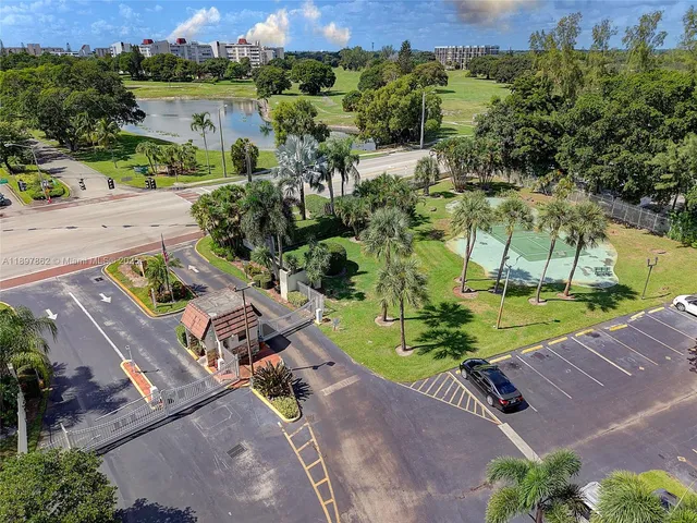 an aerial view of a house with a yard and lake view