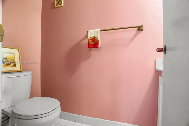 a white toilet sitting next to a shower curtain