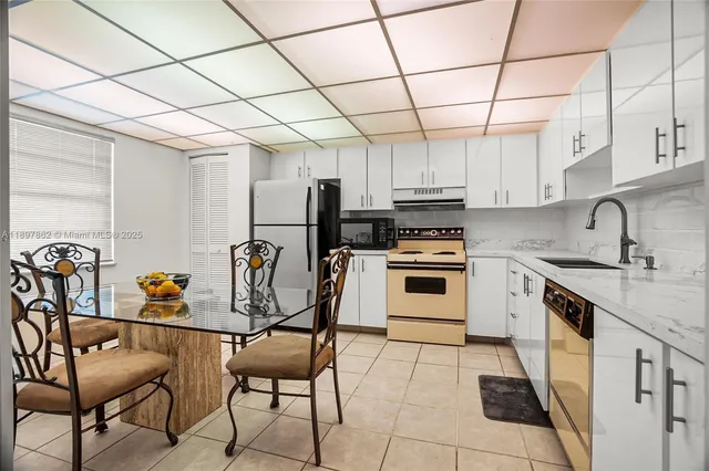 a kitchen with stainless steel appliances granite countertop a sink and cabinets