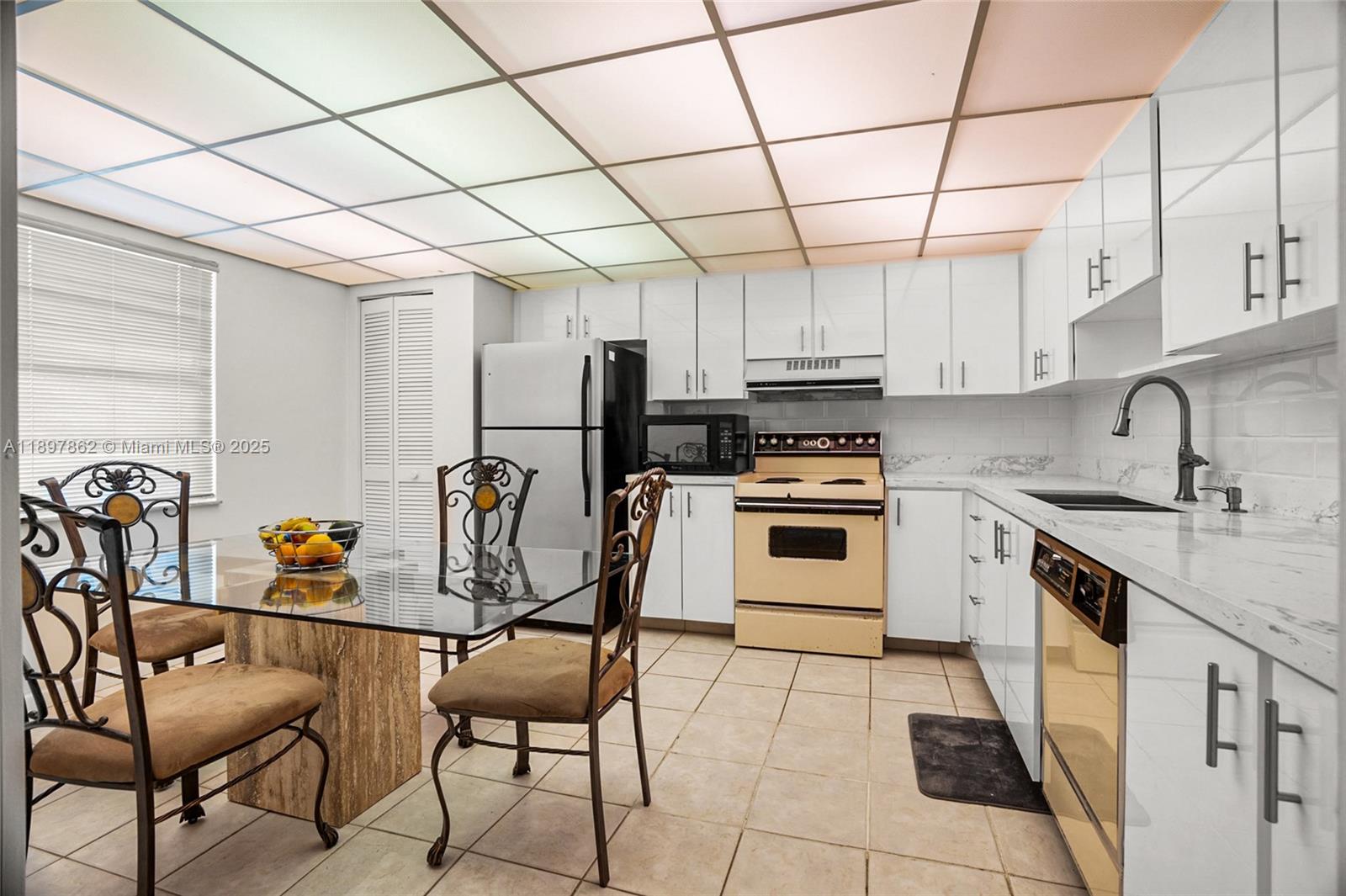 3940 Inverrary Boulevard, Unit 304A Lauderhill, FL 33319 - Photo 8 of 28 a kitchen with stainless steel appliances granite countertop a sink and cabinets