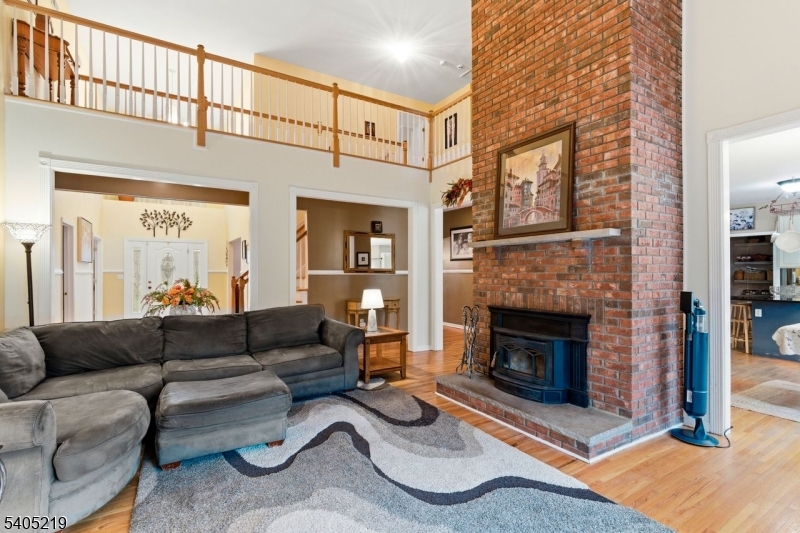 15 Mountainview Drive Andover, NJ 07821 - Photo 12 of 48 a living room with furniture a fireplace and a table