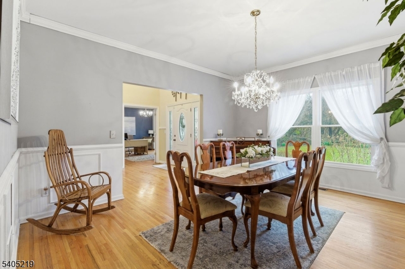 15 Mountainview Drive Andover, NJ 07821 - Photo 5 of 48 a dining room with furniture a chandelier and wooden floor