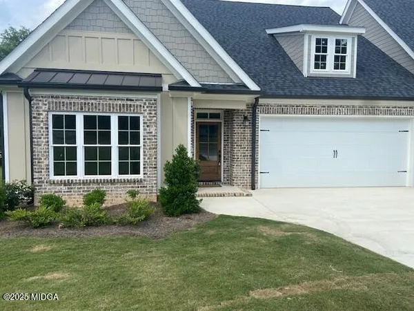a front view of a house with garden