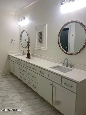 a bathroom with 2 sink and a mirror