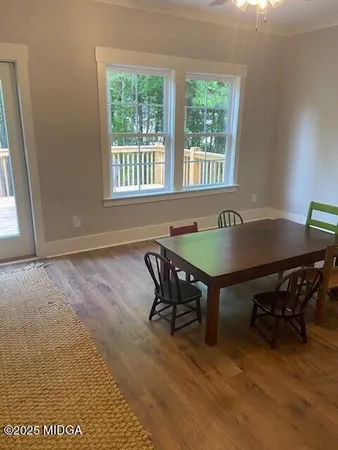 a view of a dining room with furniture and window