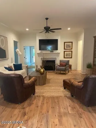 a living room with furniture flat screen tv and a fireplace