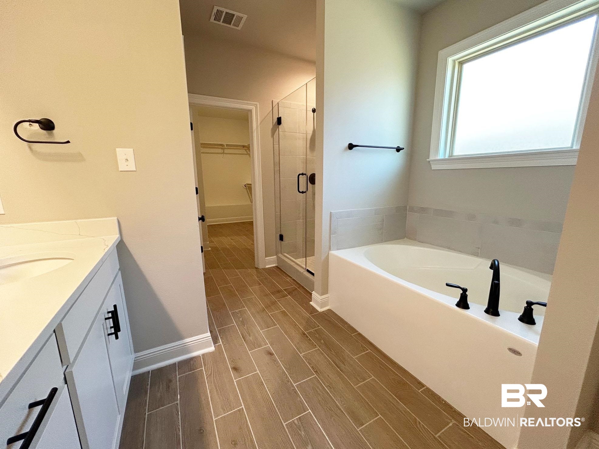 877 Sumter Loop Foley, AL 36535 - Photo 9 of 18 Full bath with visible vents, wood tiled floor, a shower stall, a walk in closet, and a garden tub
