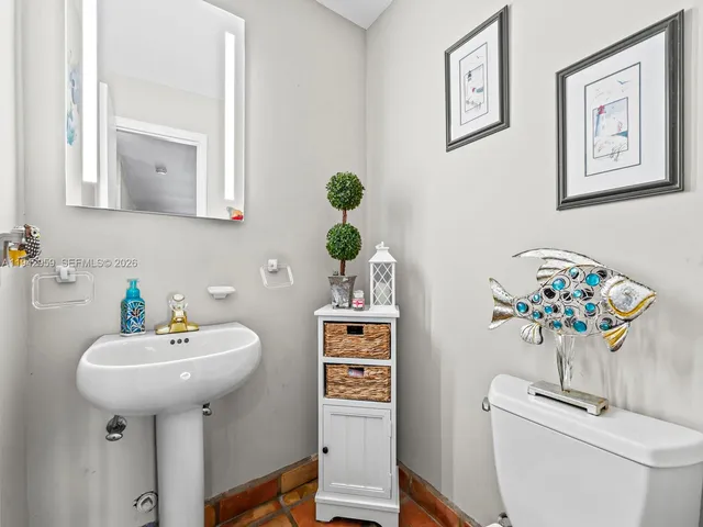 a bathroom with a sink a mirror and a toilet