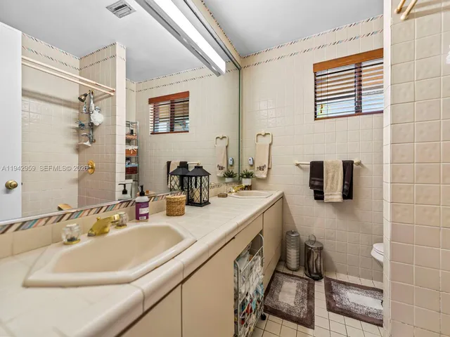 a bathroom with a sink double vanity and a shower