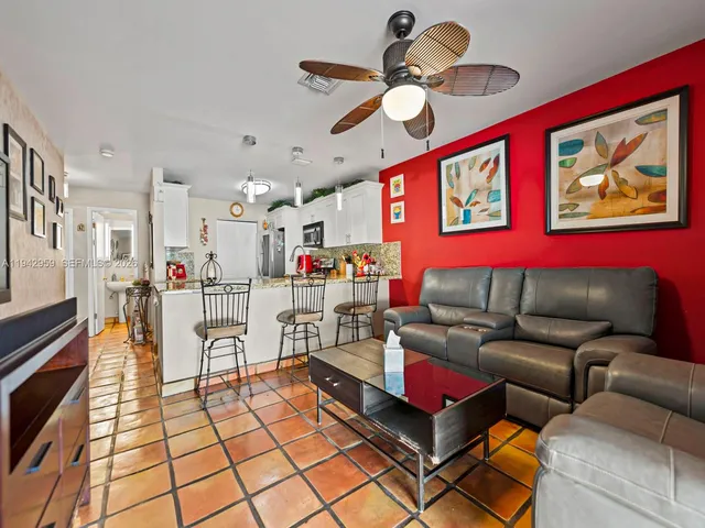 a living room with furniture and kitchen view
