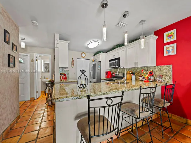 a view of a dining room with furniture and a chandelier