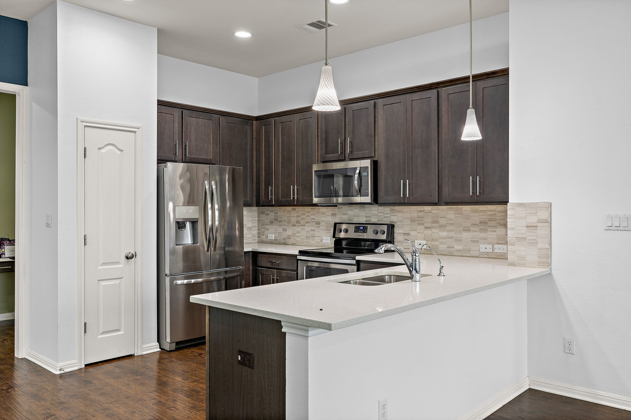 706 Coconut Grove Street Pflugerville, TX 78660 - Photo 10 of 23 The kitchen opens beautifully to the living space, creating a welcoming flow that makes entertaining easy and everyday living comfortable.
