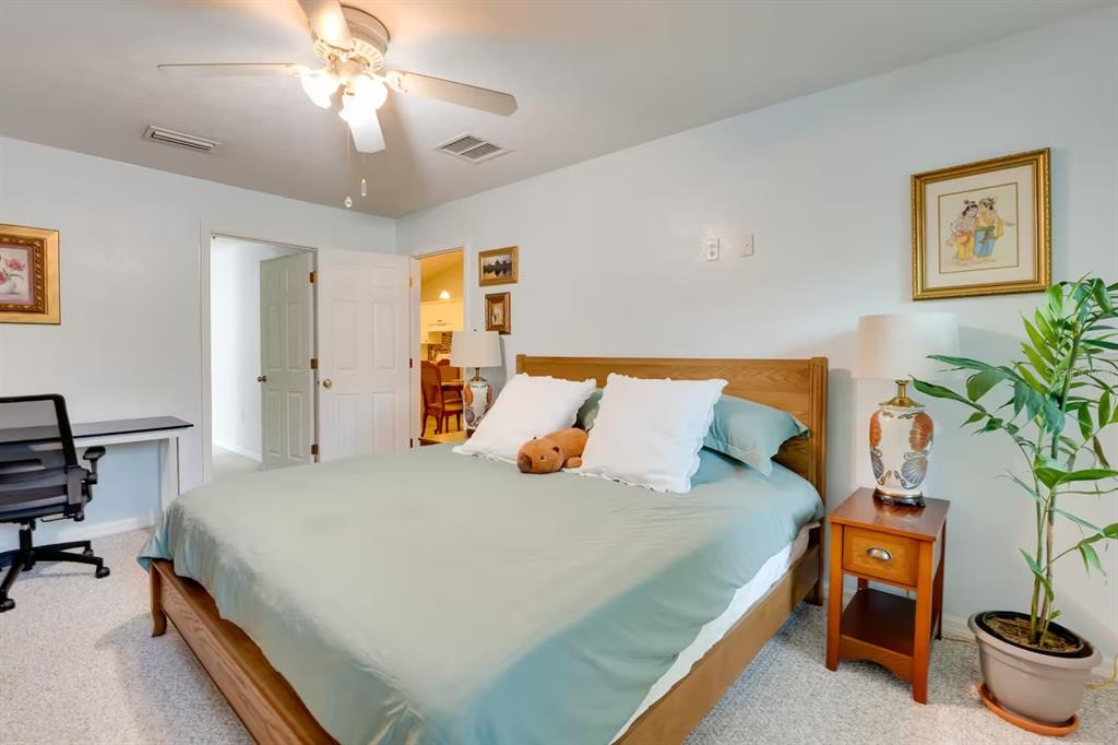 6355 Northwest 106th Place Alachua, FL 32615 - Photo 3 of 11 a bedroom with a bed and a chandelier