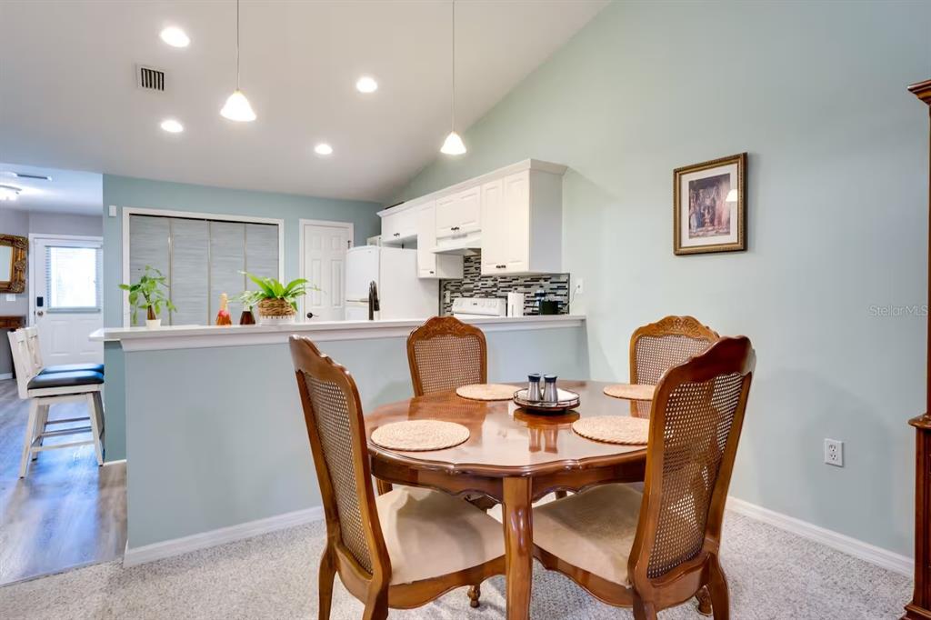 6355 Northwest 106th Place Alachua, FL 32615 - Photo 7 of 11 a dining room with furniture a window and kitchen