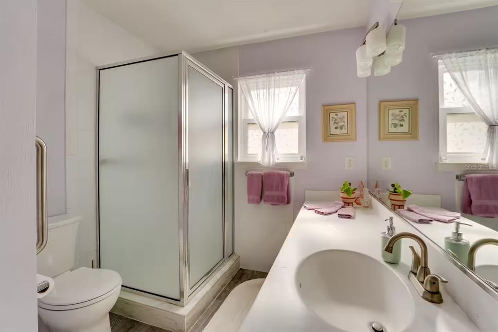 6355 Northwest 106th Place Alachua, FL 32615 - Photo 8 of 11 a bathroom with a sink a toilet and a shower