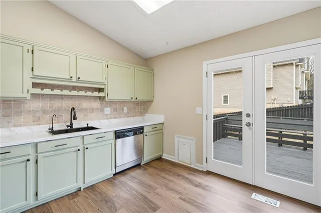 a kitchen with a sink cabinets and wooden floor