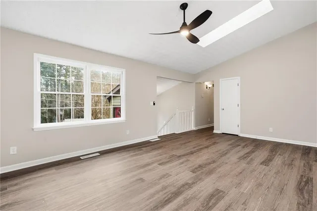 wooden floor in an empty room with a window