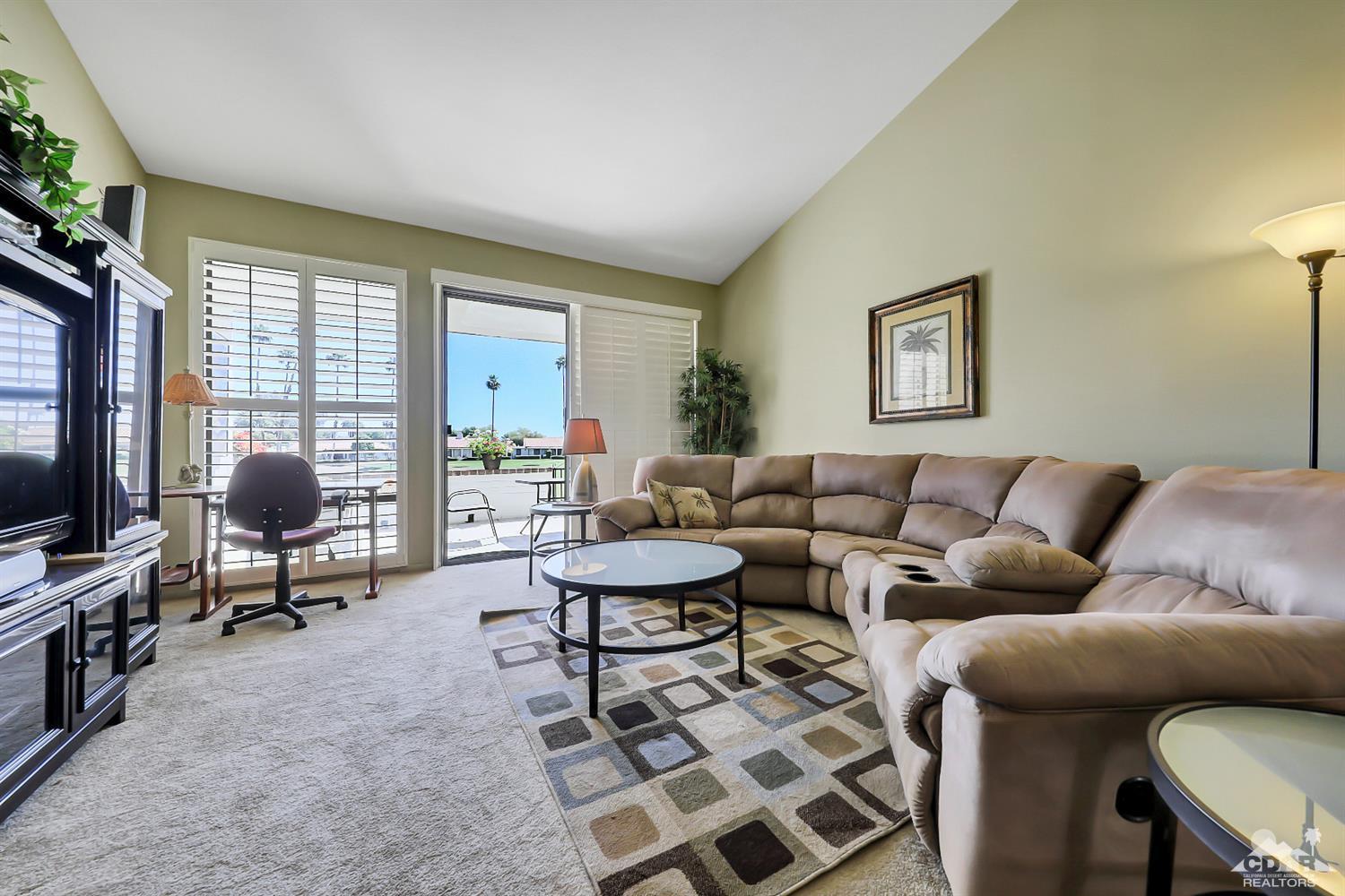52 Durango Circle Rancho Mirage, CA 92270 - Photo 2 of 20 a living room with furniture a flat screen tv and a window