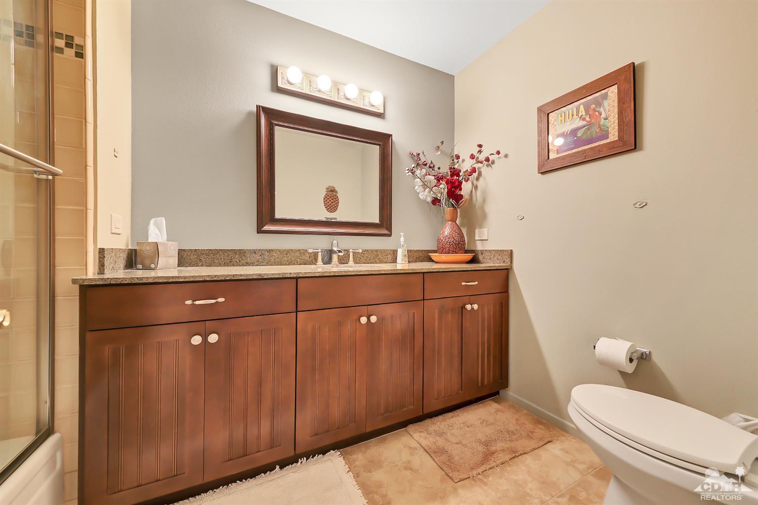 52 Durango Circle Rancho Mirage, CA 92270 - Photo 13 of 20 a bathroom with a toilet a sink and mirror