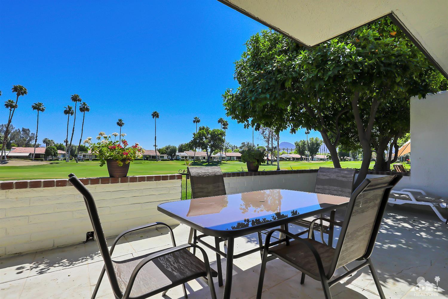 52 Durango Circle Rancho Mirage, CA 92270 - Photo 14 of 20 a table and chairs with the view of tree in the background