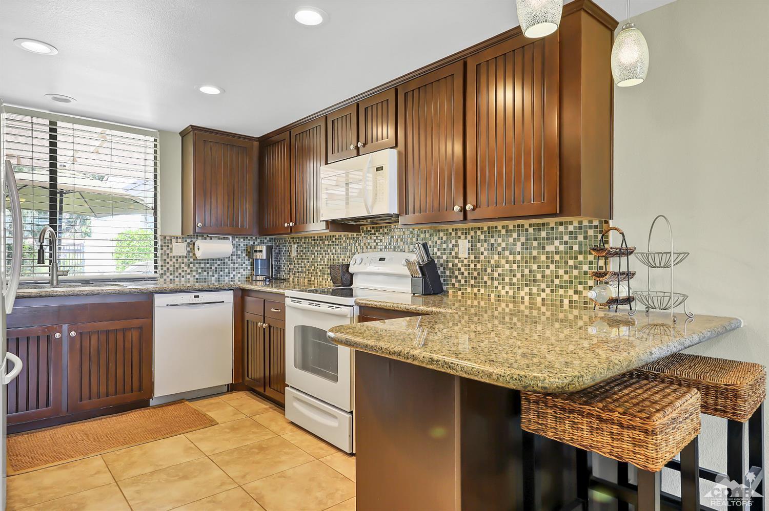 52 Durango Circle Rancho Mirage, CA 92270 - Photo 5 of 20 a kitchen with a sink cabinets and window