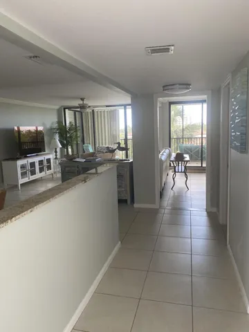 a lobby with furniture and view of living room