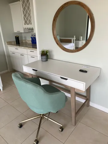 a living room with furniture and a mirror