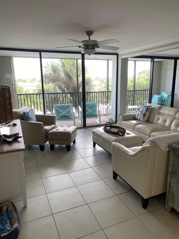 a living room with furniture and large windows