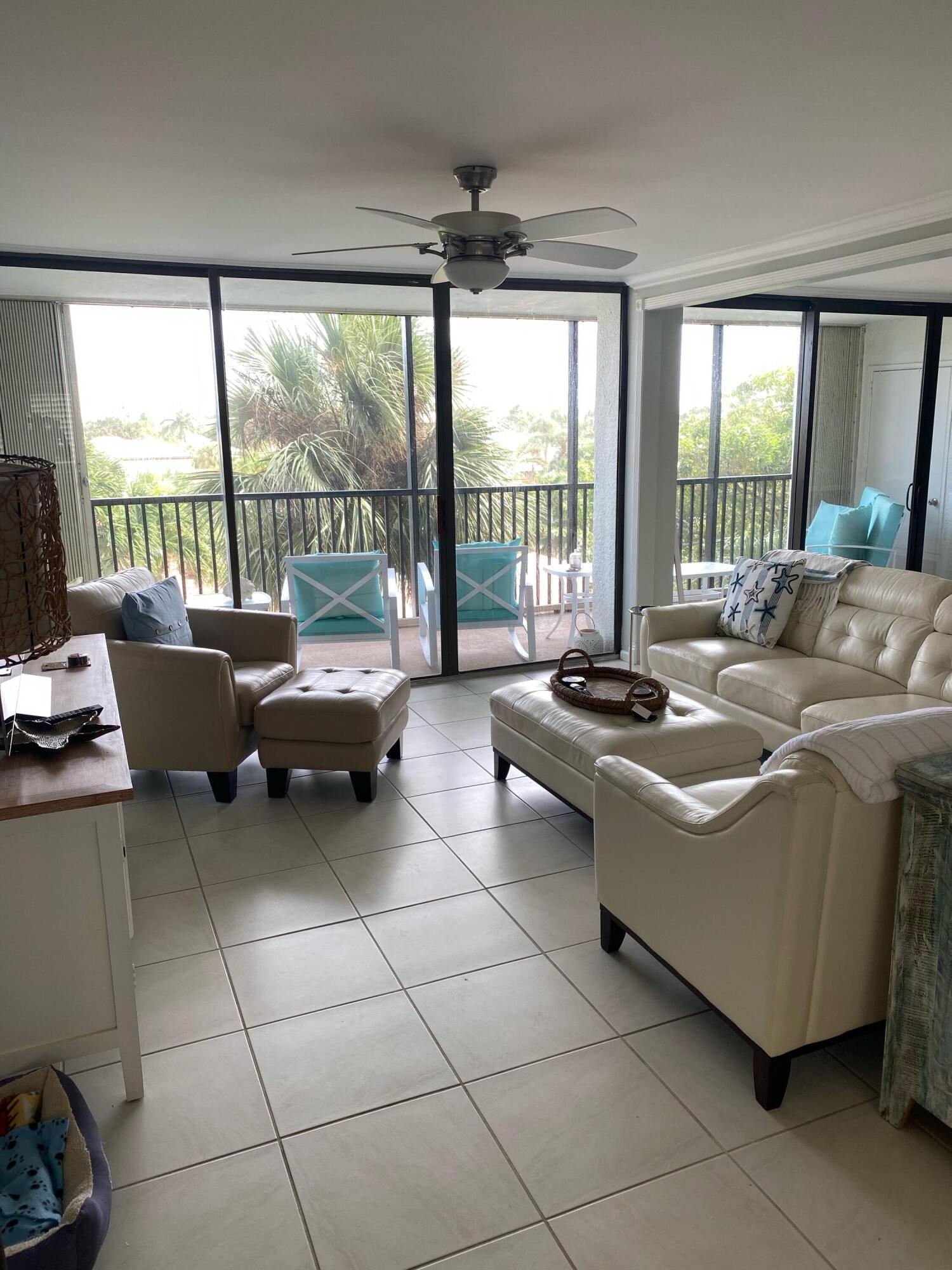 1605 Highway 1, Unit 401M3 Jupiter, FL 33477 - Photo 2 of 28 a living room with furniture and large windows