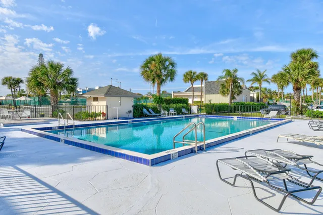 a view of swimming pool with a lounge chairs