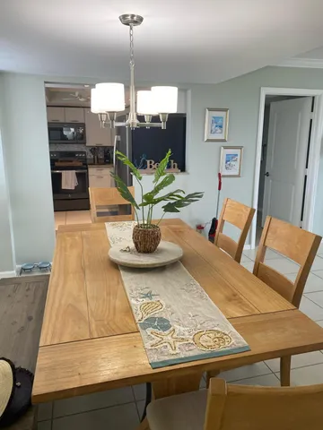 a living room with dining table and chairs