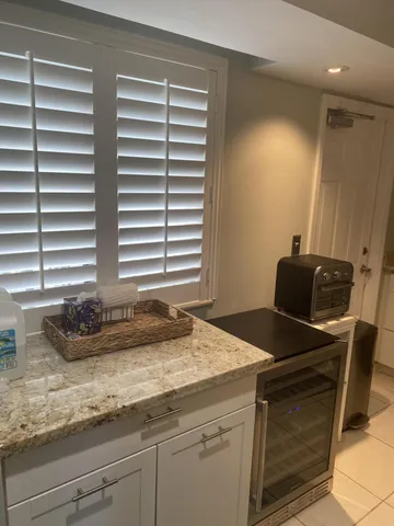 a kitchen with granite countertop a sink and a stove